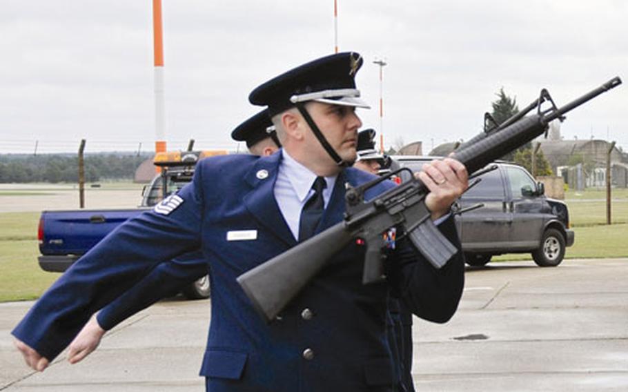 Members of the 48th Fighter Wing base honor guard perform a three-volley salute during the ceremony.