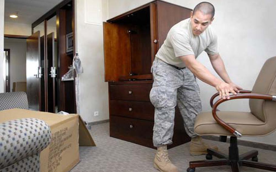 Senior Airman Mario Jaramillo, with the 435th Services Squadron, moves a chair in the eight-story billeting portion of the Kaiserslautern Military Community Center Tuesday at Ramstein.