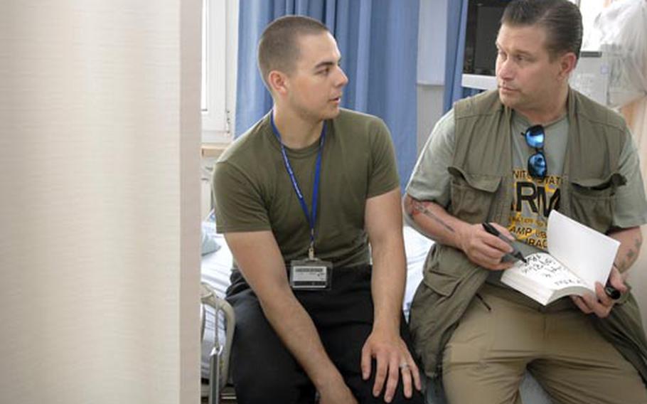 Stephen Baldwin signs a copy of his book for Miller during a visit Wednesday to Landstuhl Regional Medical Center in Germany. Baldwin is on the last leg of an Armed Forces Entertainment tour with singer Tony Orlando and other celebrities.
