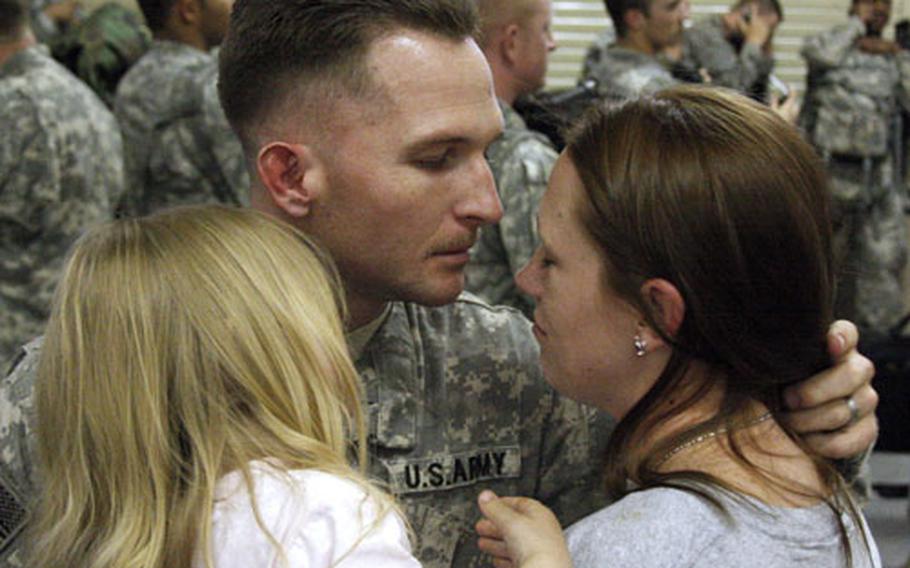 Spc. Justin Conner of HHC, 252nd Combined Arms Battalion, says goodbye to his wife, Danielle.