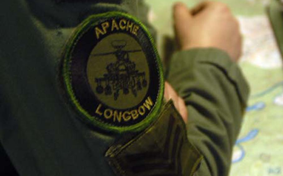 A British Army Air Corps soldier&#39;s uniform bears the patch of the unit&#39;s aircraft, the Apache Longbow.