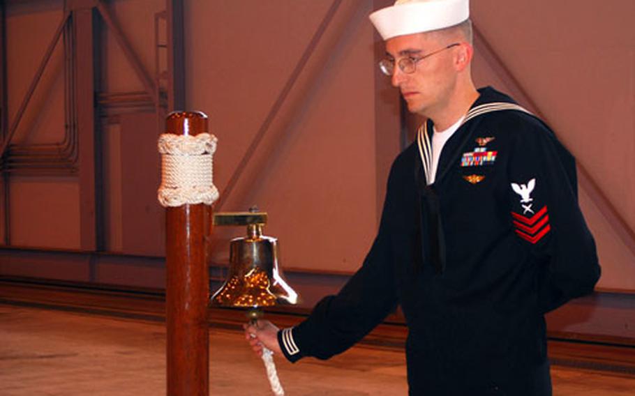 Petty Officer 1st Class Eli Redstone rings the bell twice for each of the 31 U.S. troops killed on April 15, 1969, when North Korean fighters downed their EC-121 reconnaissance plane over the Sea of Japan. Wednesday’s ceremony marked the 40th anniversary of the attack.