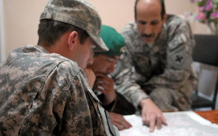 Capt. Jim Gingras, the Kapisa Provincial Reconstruction Team’s lead engineer, discusses options for inspecting a road project in Tag Ab, Afghanistan, with the commander of the local Afghan National Army unit (not pictured). The commander refused to let his soldiers go with the Americans because he thought the only route open was too dangerous to travel on such short notice.