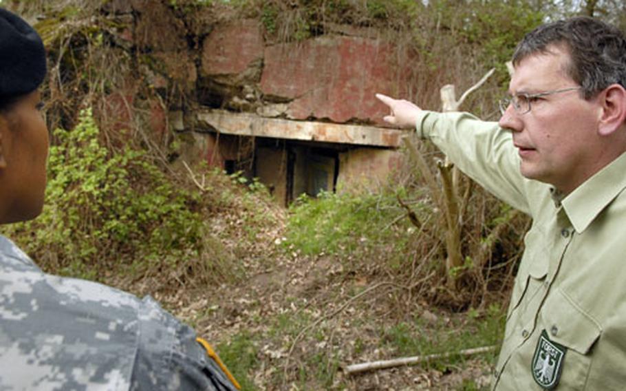 Josef Brocher,a German forest ranger, shows a modified bunker used as a winter getaway for bats to Lt. Col. Mechelle Hale, the commander of U.S. Army Garrison Kaiserslautern, Wednesday in Miesau. Brocher, in conjunction with Dr. Claudia Weber, an environmental engineer for the USAGK, is creating habitats for bats that find themselves on the endangered or threatened species list.