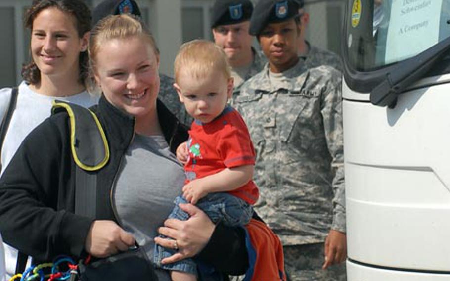 Lisa Huerth, holding her son Lochlan, 13 months, smiles upon arrival at Ledward Barracks in Schweinfurt, Germany, Wednesday for a tour of the community and the city of Schweinfurt.