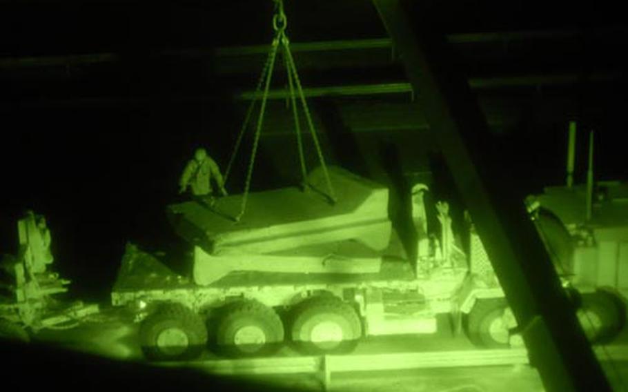 Soldiers with the 5th Squadron, 4th Cavalry Regiment guide concrete barriers on to a truck in the Khadra neighborhood of northwest Baghdad.