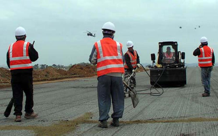 At Camp Humphreys in South Korea Friday, work is underway to make major improvements at Desiderio Army Airfield. The work, to be completed in late May, includes repaving of a portion of the runway and installation of a fire hydrant system. In this photo, workers fill cracks that have formed under the runway’s surface.