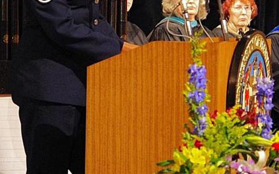 Air Force Chief Master Sgt. Rita A. Green, the superintendent at 18th Equipment Maintenance Squadron, 18th Maintenance Group, 18th Wing, Kadena Air Base, Okinawa, addresses the University of Maryland University College Asia graduates Saturday during the commencement ceremony on Okinawa.