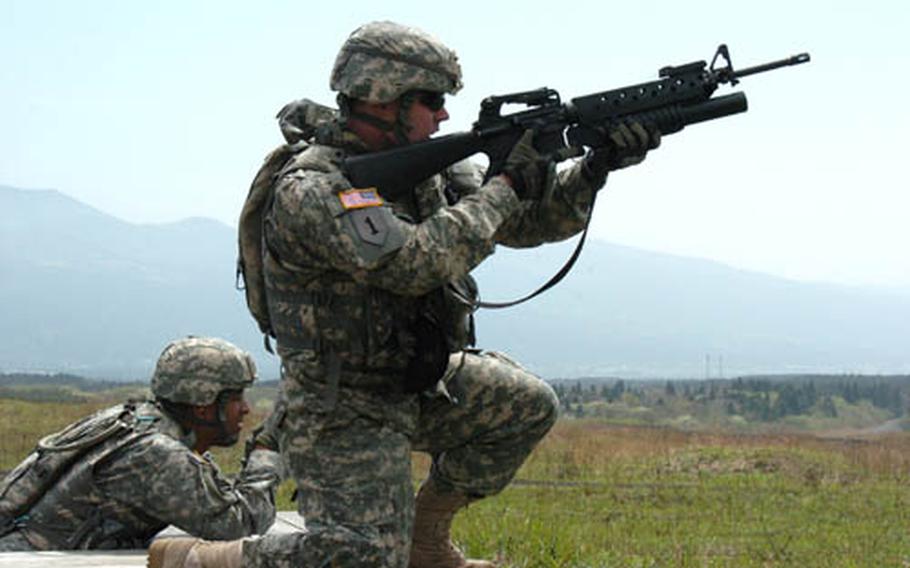 A soldier with 35th Combat Sustainment and Support Battalion measures his shot while training with the M-203, with an underslung grenade launcher, at Camp Fuji.