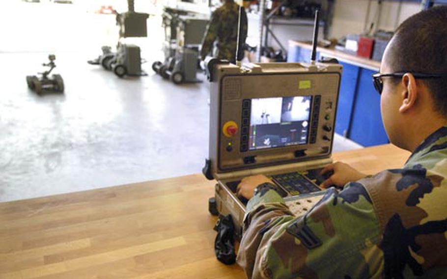 Corona guides a robot out on a training mission Tuesday at Ramstein Air Base.