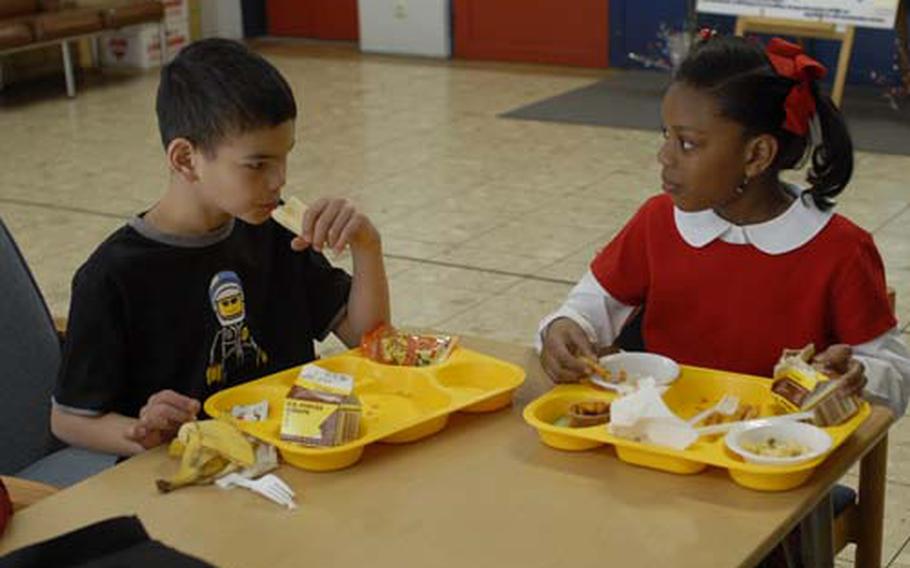 Vogelweh Elementary School second-graders Anthony Russell, 8, and Aria Millsap, 8, enjoy a school lunch. Changes could be made to the meals next school year based on a survey of students, parents and administrators.