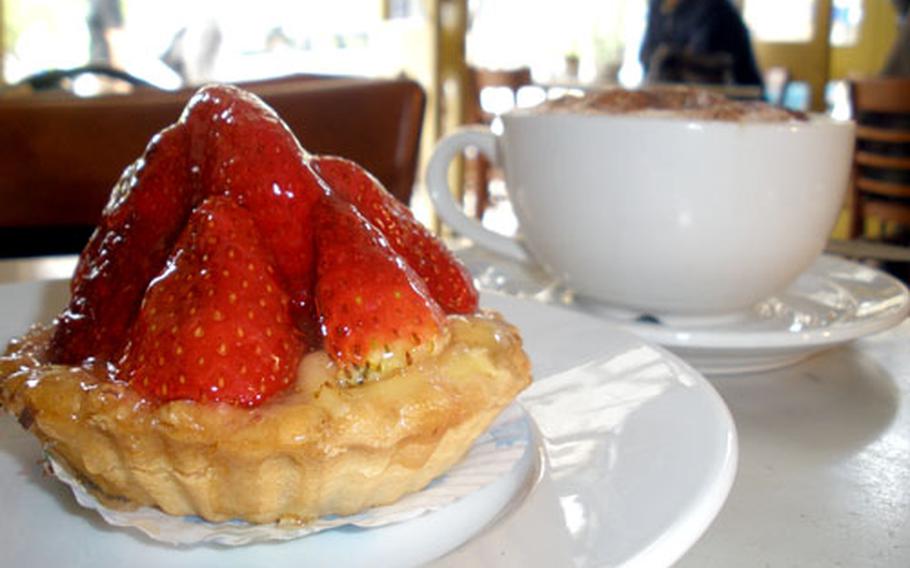 A strawberry tart and cappuccino at Le Gros Franck, a bistro in Cambridge.