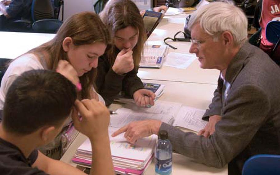 Mike Lowry, a history tutor, works with students enrolled in the AVID program at Patch High School. From left to right, Alex Vitt, Amelia Hartman and Hannah Minton, work on the latest lesson.