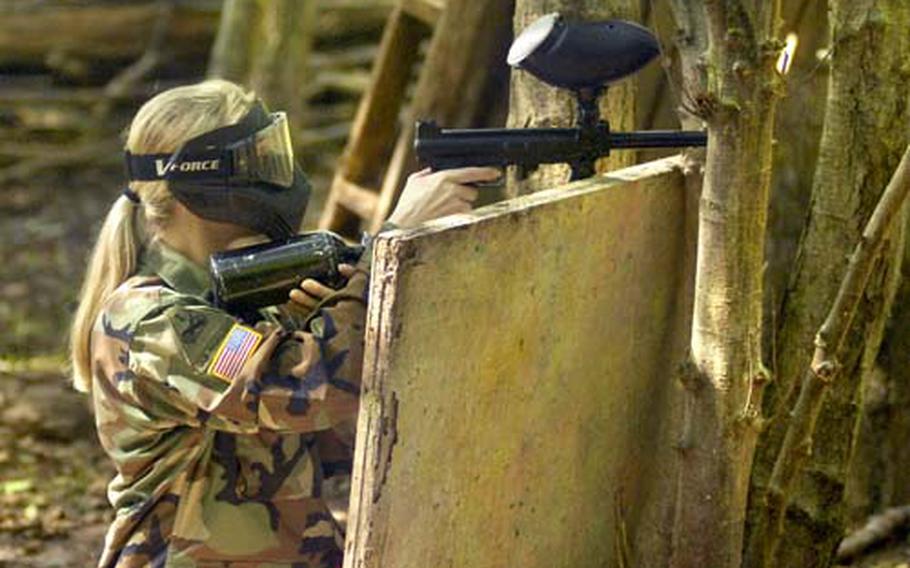 An Army spouse takes cover in a paintball war during a portion of the Iron Spouse Challenge Sep. 11th, 2008 at Baumholder. German lawmakers have abandoned a recent attempt to make paintball or laser tag illegal.