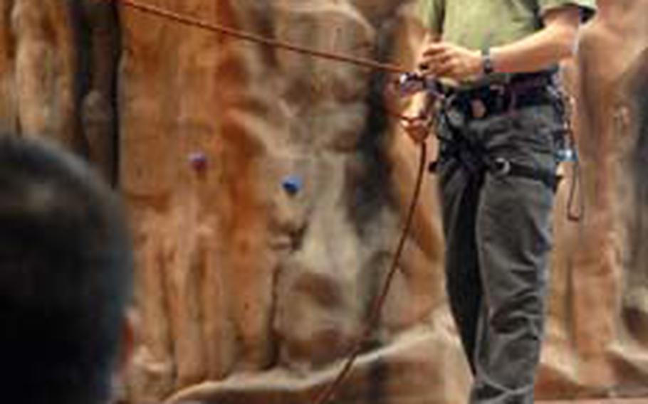 Jon Tierney, a Professional Climbers Instruction Association trainer, talks about belay techniques Friday during an instructor course.