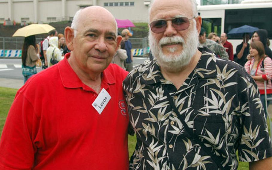 Levon Martin, left, representing the class of 1961, and Lyle Bishop, representing the class of 1960, pose for a picture following the tree planting ceremony at Zama American High School.