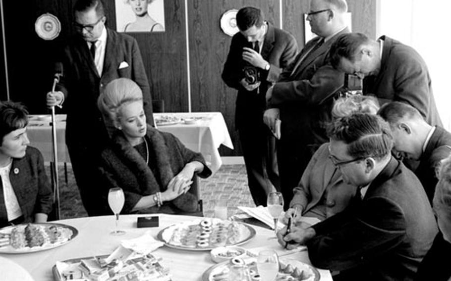 Tippi Hedren talks to reporters afterc arriving in Frankfurt on a promotional tour for "The Birds."