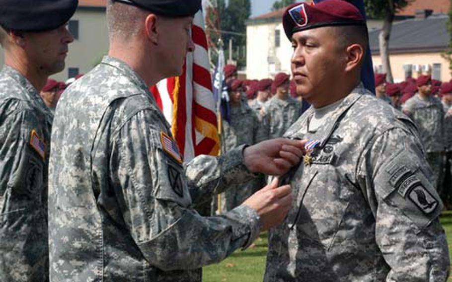 Maj. Gen. William B. Garrett pins the Silver Star on Staff Sgt. Conrad Begaye during a ceremony Tuesday on Caserma Ederle in Vicenza, Italy. Begaye was honored for his actions in a battle near Aranas, Afghanistan, in which five fellow soldiers and a Marine were killed.