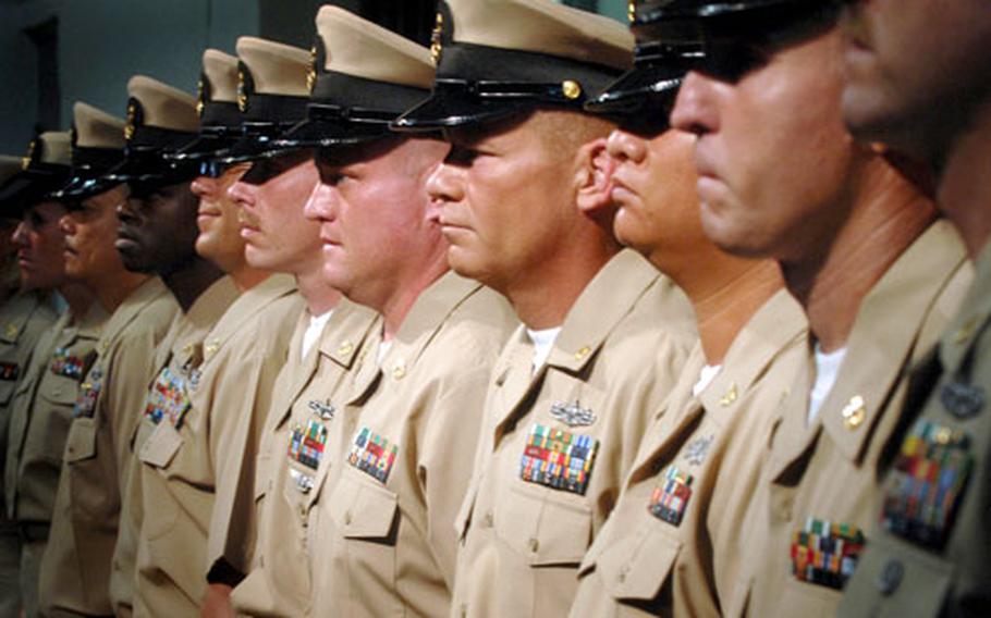 Newly-pinned chief petty officers stand at attention during Naval Station Guantanamo Bay&#39;s chief pinning ceremony in September, 2008.