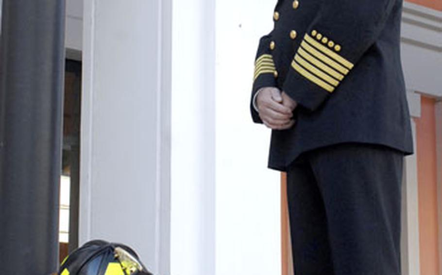 Naval Support Activity Naples Fire Chief Roland Hesmondhalgh bows his head to remember the victims of the Setp. 11, 2001, attacks after a memorial service at the Capodichino Navy base Friday. The memorial service at Naples was one of several held at U.S. military bases across Europe.