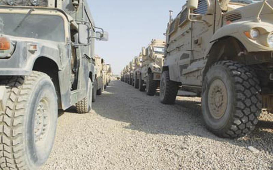 Rows of Humvees and armored trucks sit on a dirt lot at Victory Base Complex in Baghdad, awaiting shipment out of Iraq. They’re destined either for Afghanistan or refurbishment in the United States.