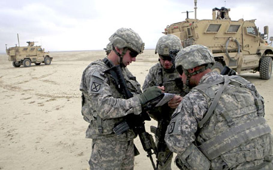 U.S. Army 1st Lt. Kevin Ellerbrock, left, looks at a map with Staff Sgt. Bejnjamin McKinnon, center, and another unidentified soldier as they prepare to go on a patrol near the town of Baraki Barak, Logar province, Afghanistan, last month.