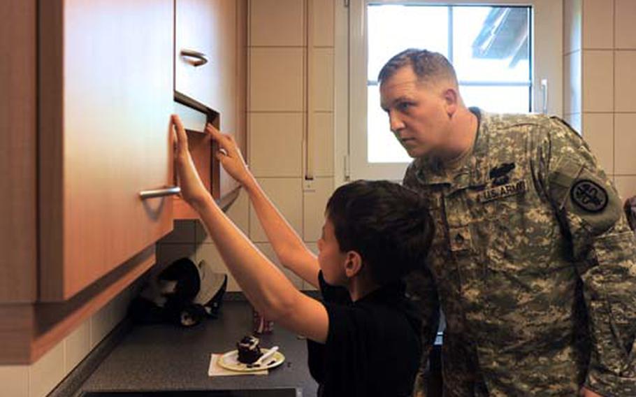 Staff Sgt. Samuel Loague and his son, Alex, check out the kitchen of their new house on Ramstein Air Base on Nov. 18. The Loague family moved into the house the next week.