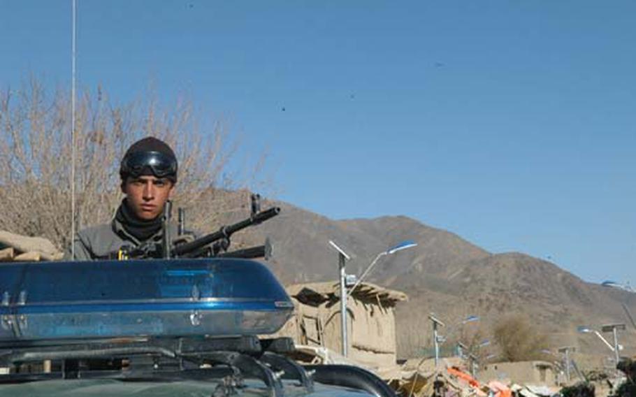 An Afghan National policeman patrols in Jalrez valley in Wardak province.