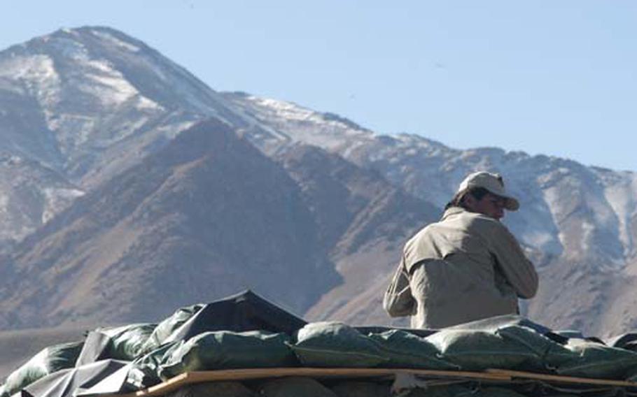 A private Afghan security guard stands watch at Combat Outpost Apache in the Jalrez valley of Afghanistan&#39;s Wardak province. Earlier this year, another private Afghan security guard climbed down from his tower at Wardak&#39;s Forward Operating Base Airborne and fired rounds into soldiers&#39; living quarters before escaping. No one was injured.