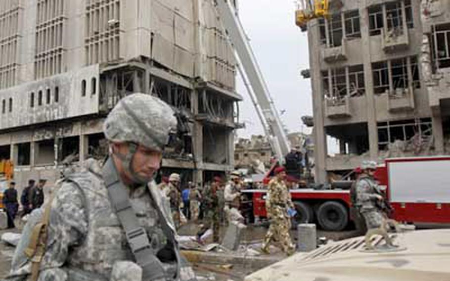 U.S. and Iraqi soldiers secure a massive bombing site near the new Finance Ministry in Baghdad on Tuesday. A series of attacks killed at least 127 and wounded more than 500.