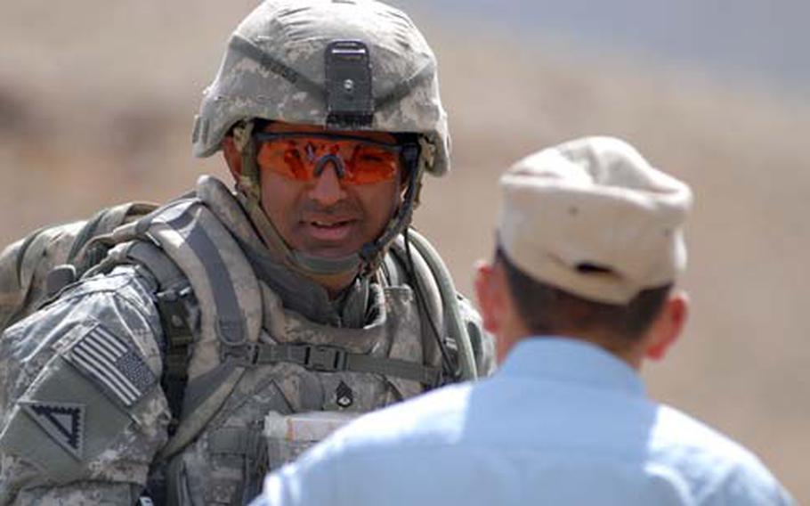 Staff Sgt. Azhar Sher from Company B, 1st Battalion, 4th Infantry Regiment speaks with an Afghan National Police officer in Zabul province, Afghanistan, during a deployment in March. Since returning to Europe, the Army has assigned Sher to Heidelberg, where he is trying to get a waiver that would allow him to move off base. Sher had argued that living on base was difficult for his extended family because he is a Muslim. The Army has denied his request.