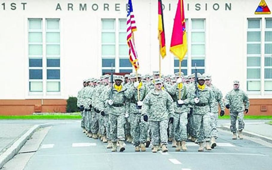 Soldiers of the 1st Armored Division, led by division chief of staff Col. Mark Calvert, march down Wiesbaden Army Airfield’s main street and past division headquarters on their way to a colors casing ceremony Friday evening﻿.