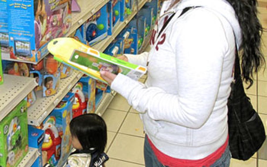 Satsuki Mcgee looks at a Tag Jr. at the Yokosuka Naval Base, Japan, Navy Exchange on Wednesday. NEX officials in Yokosuka said the Tag Jr. toys have been among their biggest sellers this year, matching sales data in the United States.