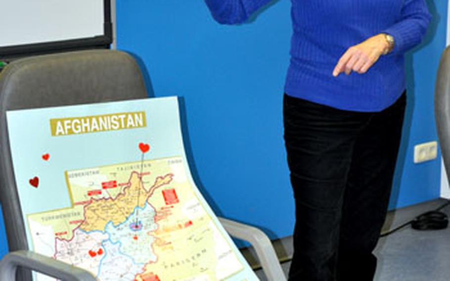 Beverly Brinn points to a map of Afghanistan that is marked with hearts representing approximately where students&#39; parents are currently deployed.