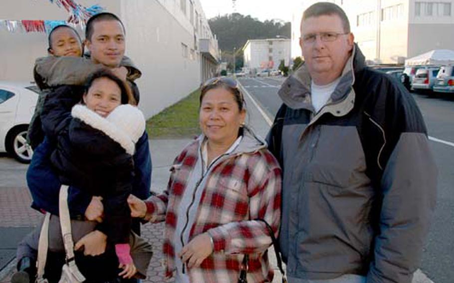 Maria Williams, center, and husband Petty Officer 1st Class Byron Williams, right, with other members of Yokosuka Naval Base’s Filipino community, say they are helping their family members still living in the Philippines after the fall’s severe storms devastated the islands.