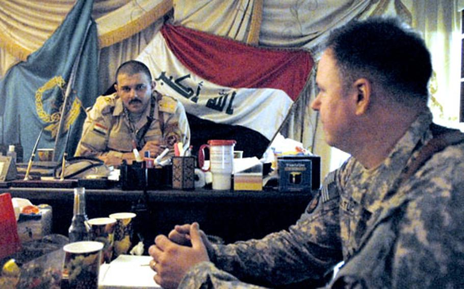 Iraqi Army Col. Abbas Fadhil Sahib has tea with U.S. Army Lt. Col. Douglas Boltuc. Abbas has won wide praise from U.S. military advisers since taking command of Iraq&#39;s premier military training center in 2006. His relations with his own superiors, however, have been more problematic.