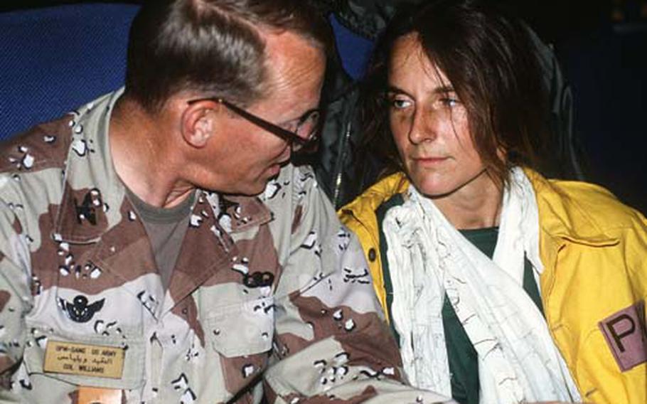 Then-Maj. Rhonda Cornum, a flight surgeon assigned to the 2nd Battalion, 229th Aviation Brigade, sits next to U.S. Army Col. Richard Williams on a C-141B Starlifter transport aircraft after her release by the Iraqi government during Operation Desert Storm in 1991. Cornum was held for eight days as a prisoner of war.