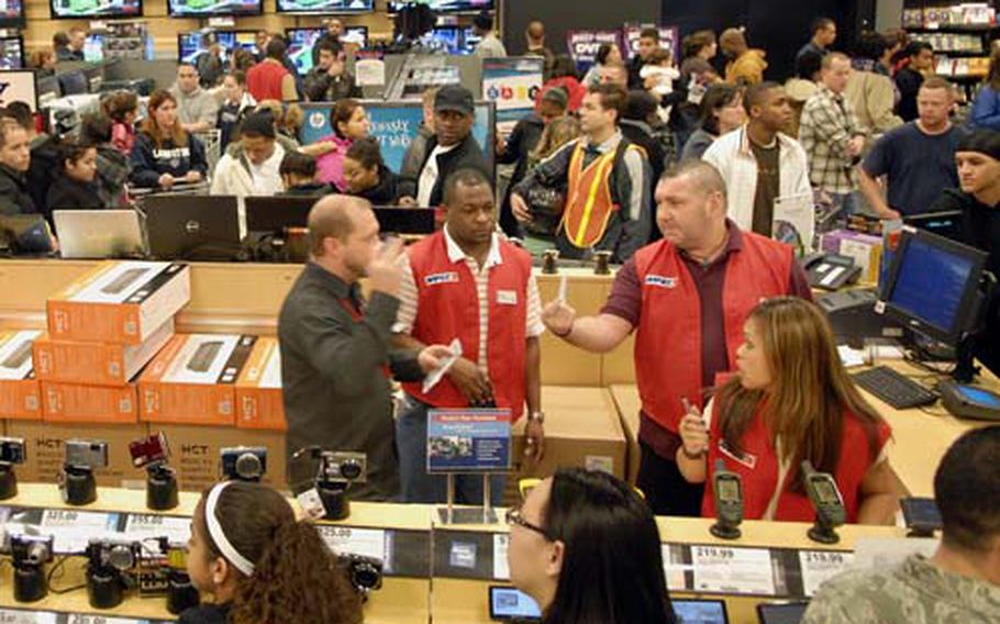 Power Zone employees work through the bustling "Black Friday" crowd at the Kaiserslautern Military Community Center Base Exchange, Nov. 27, 2009. AAFES holiday sales were up more than 12 percent from last year at Pacific and Europe locations, AAFES offiicials said.