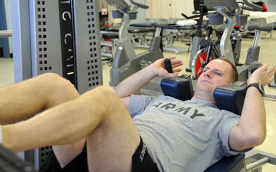 Staff Sgt. John Engel uses a functional squat machine at Irwin Army Community Hospital’s physical therapy clinic as part of his rehabilitation. Engel’s Warrior Transition Battalion at Fort Riley, Kan., will be among the first to move into a barracks complex meant to help wounded troops recover.