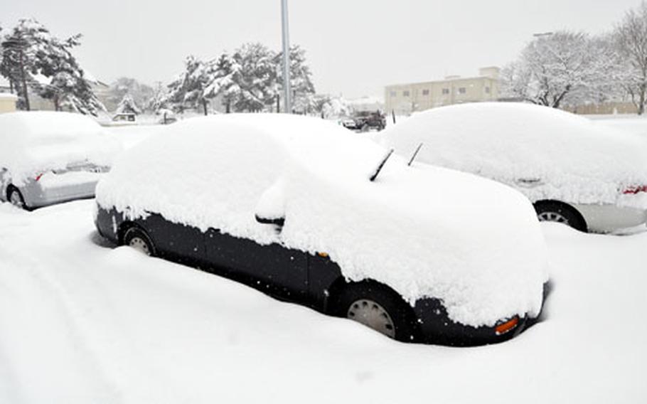 Cars are buried under heavy snow that began Tuesday afternoon and continued to fall through Wednesday morning at Misawa Air Base, Japan.