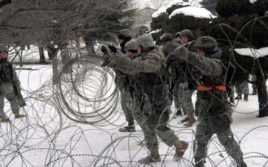 At Kunsan Air Base in South Korea on Monday, airmen of the 8th Fighter Wing set up concertina wire during a mock air war exercise the U.S. 7th Air Force (Air Forces Korea) held across South Korea from Monday to Friday.