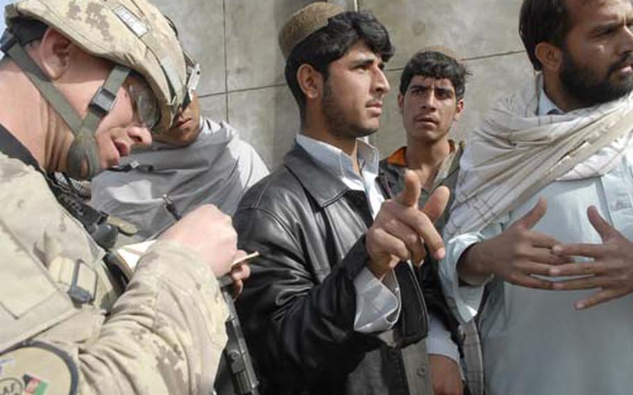 Sgt. Tom, a Canadian soldier who goes by just one name for security reasons, talks to villagers just outside of Kandahar to document their day to day issues, such as security, education, and clean drinking water.