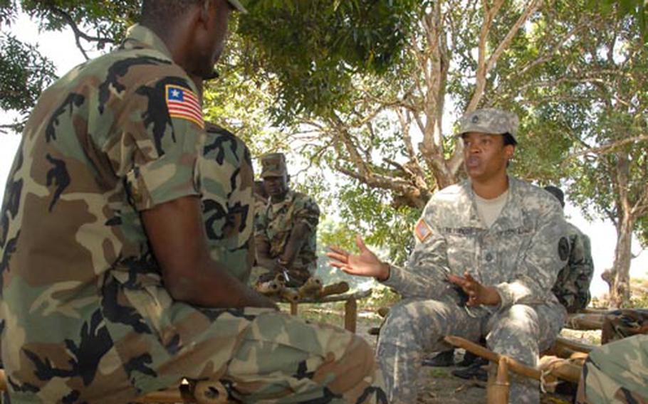 Sgt. 1st Class Shanwte Reynolds, 39, of Flint, Mich., a U.S. Africa Command NCO, discusses leadership with soldiers from the Armed Forces of Liberia during a recent mentorship session at Edward Binyah Kesselly Military Barracks near Monrovia.