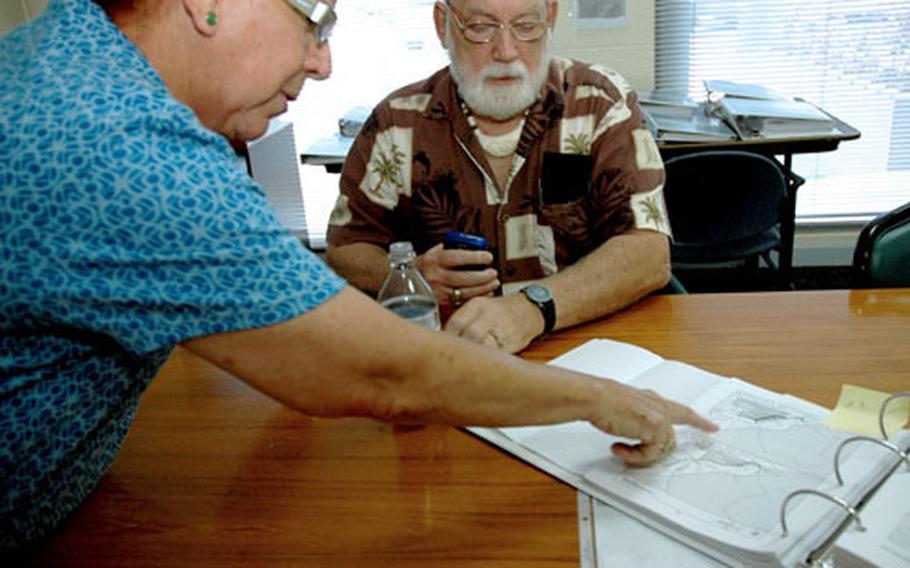Guam Sen. Judith Guthertz, who chairs the legislative committee on the buildup, looks at part of the military’s proposal with her chief of staff, retired Navy captain Richard Wyttenbach-Santos. Guthertz has requested the military take another look at its own land – including the 15,000 acres it has at Andersen Air Force Base – before asking to buy or lease Guam-controlled land.