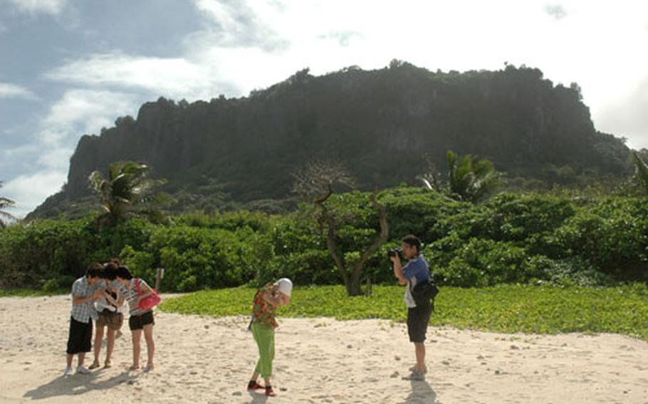 The hotels and the military control access to some of Guam’s beachfront, like this area at Ritidian Point just on the outside of Andersen. The beach is controlled by the U.S. Fish and Wildlife Service, which allows access to the sand but not the water during the day. Tourists, like this family from South Korea, come to visit, take photos and look for crabs.