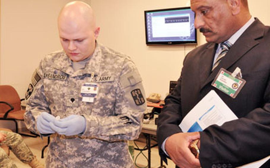 Spc. James Lysandrou, of the 932nd Blood Support Detachment, shows a rapid test for HIV and Hepatitis B and C to Faez Farhan Muhammad, director of the Ibn Firnas clinic in Albu Hassan. Staff from Muhammad&#39;s clinic will soon learn with their American peers at a new medical training facility just outside the gates of Balad.