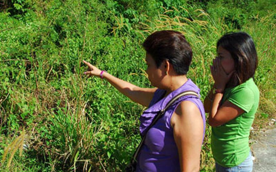 Ruby Ramores (center) in November shows Lilibeth Eniceo the spot along a rural road where her brother was shot to death and left. Eniceo says she hired the gunman who did the shooting.