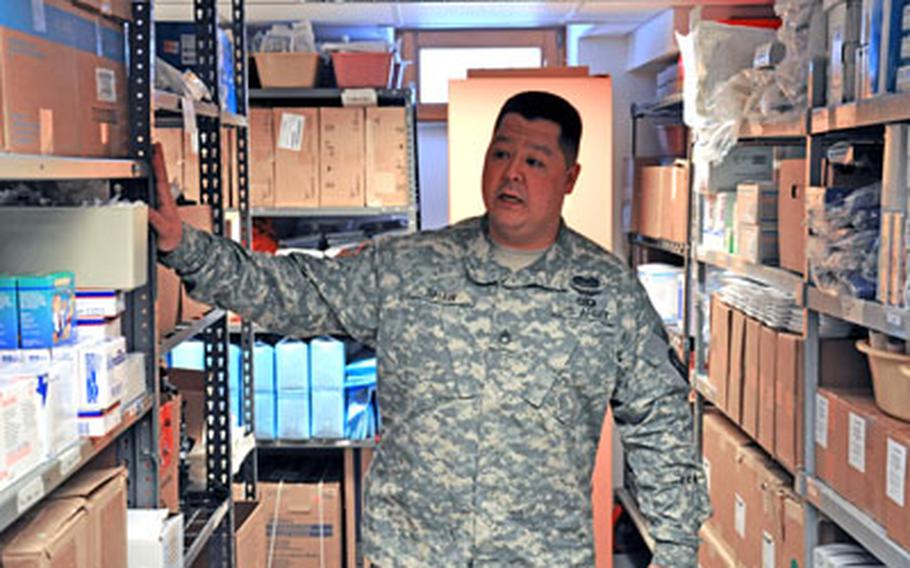 Staff Sgt. Michael Shaw gives a tour through the aid station supply room located in Warner Barracks in Bamberg, Germany. Shaw is a pharmacy noncommissioned officer.