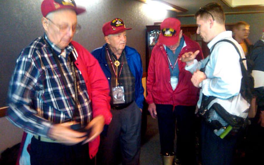 World War II veterans wait at Kadena Air Base for their flight to Iwo Jima.