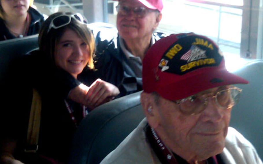 Veterans Max Brown, front, and Don Whipple and a student take the bus to the plane.